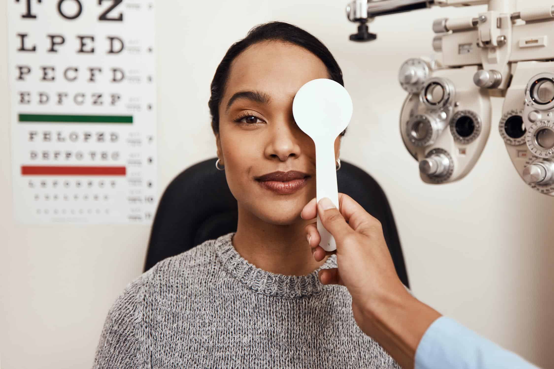 Optometrist performing eye exam with phoropter at Southcentre Mall.