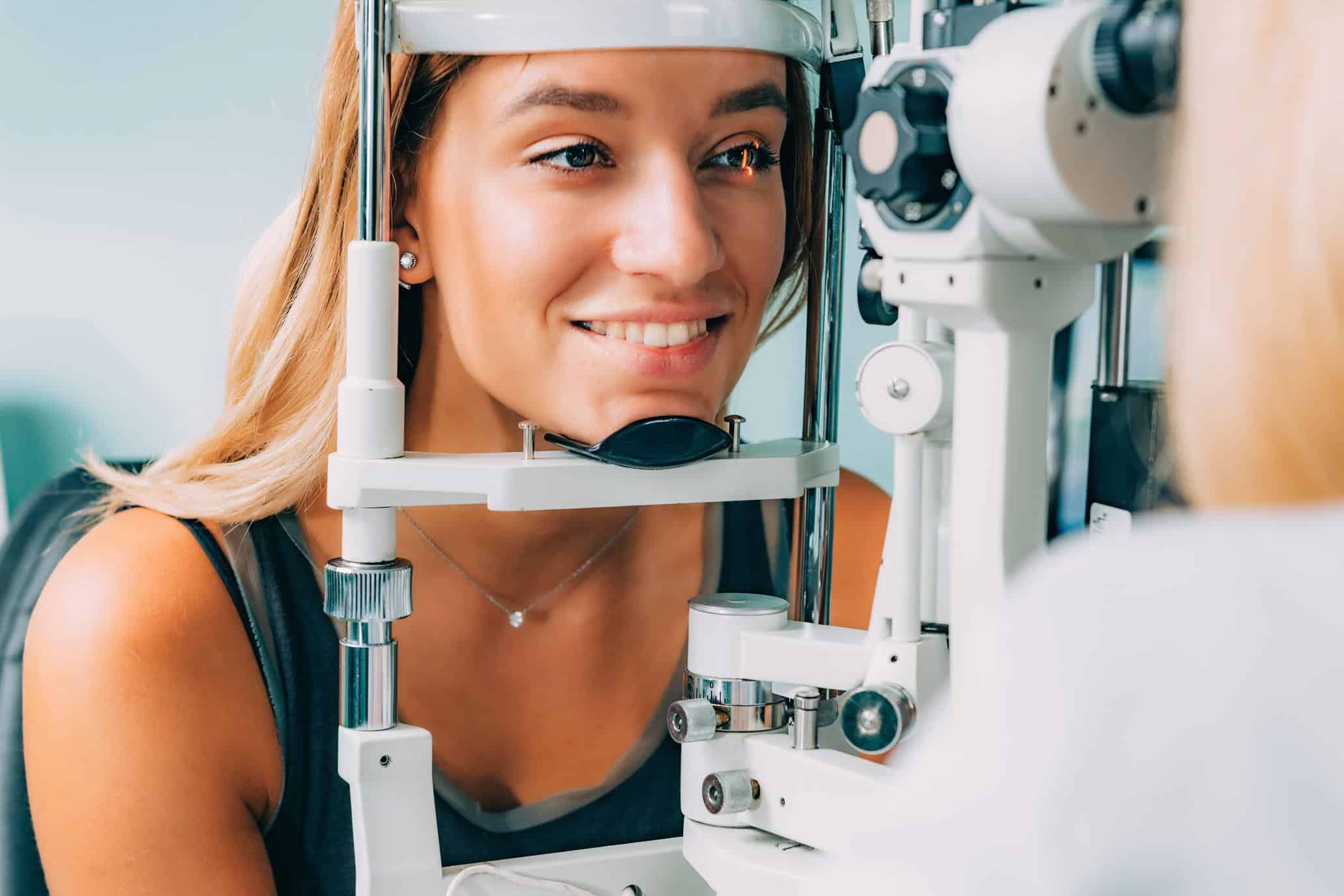 Young woman undergoing an eye exam with specialized equipment at Southcentre Eye Clinic.